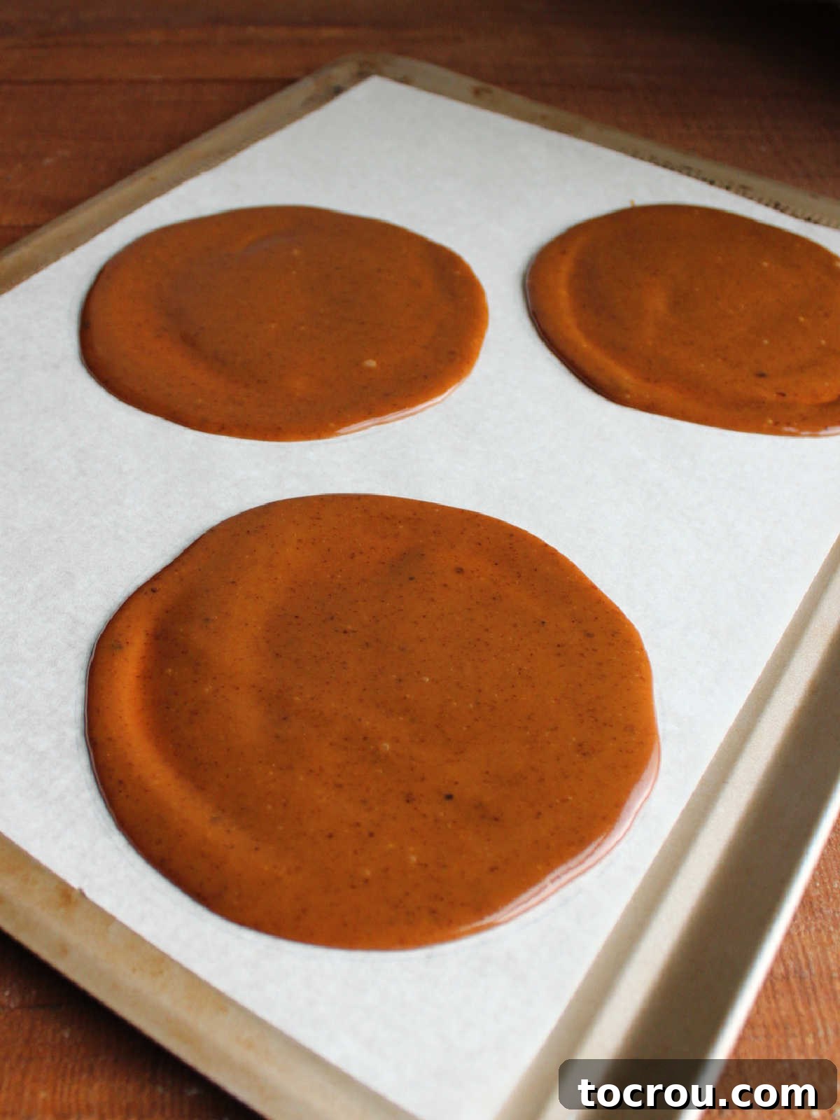 Circles of homemade caramel ready to be chilled to become caramel apple wraps.