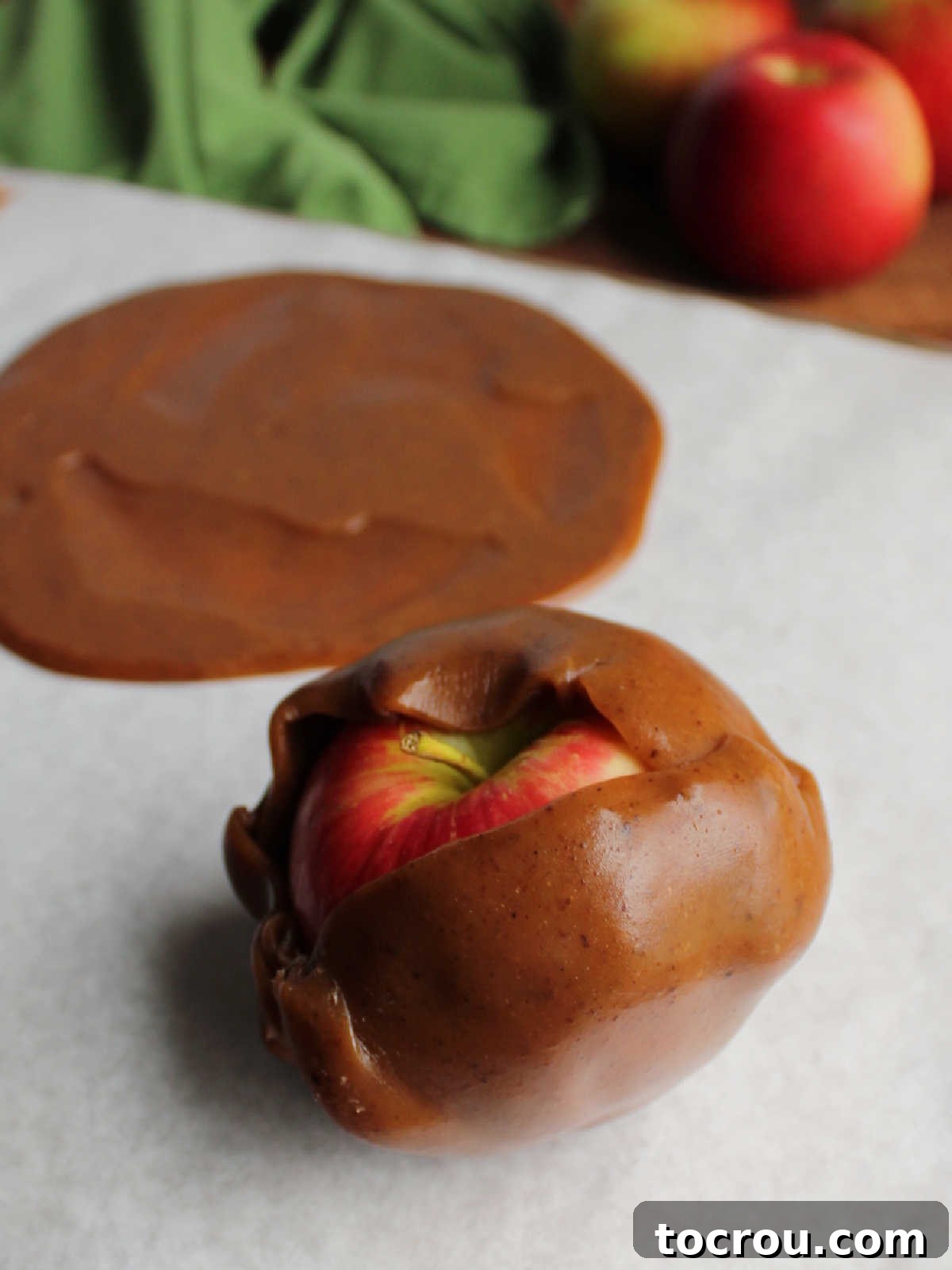 Caramel wrap circle wrapped around an apple with seams still showing. 