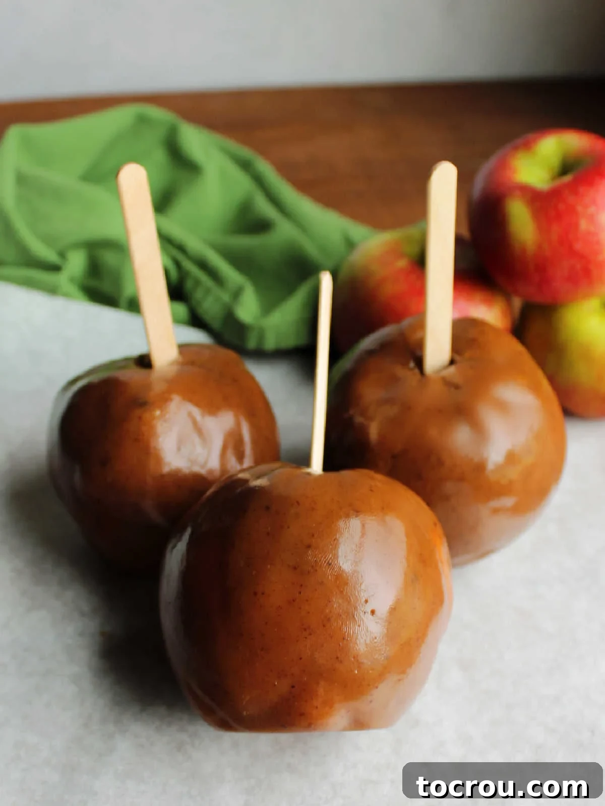 Collection of caramel apples made with homemade caramel wraps, ready to be enjoyed. 