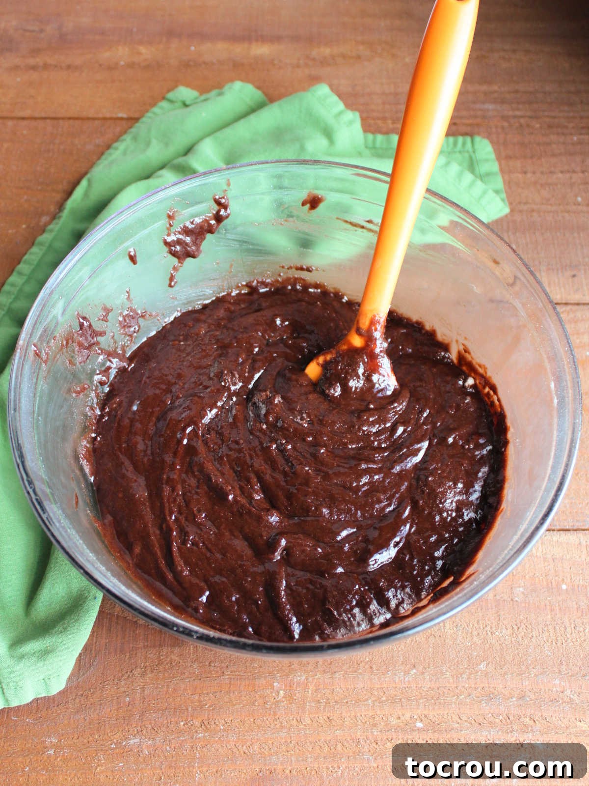 Thick brownie batter made from brownie mix, eggs, oil, and vanilla extract ready to go in the pan.