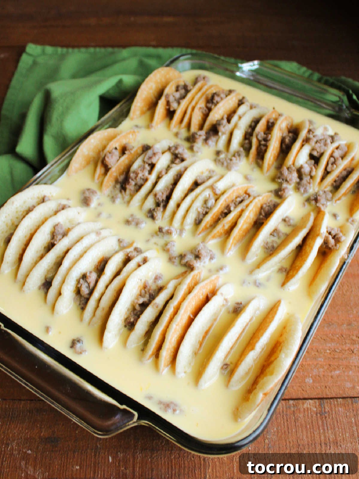 Casserole dish after all of the egg mixture has been poured in with the pancakes and sausage, ready to soak in the fridge for a few hours. 