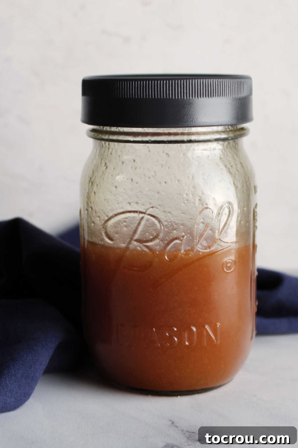 Jar of homemade salad dressing ready for salad.