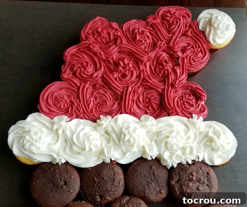 Santa hat made out of cupcakes and frosting, showing the vibrant red and white trim.