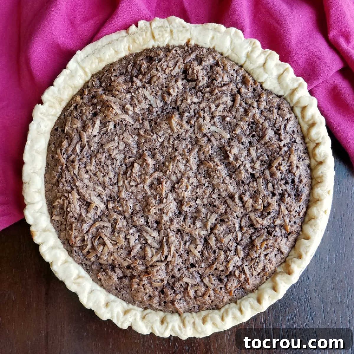 A whole chocolate macaroon pie, beautifully baked and loaded with a rich chocolate and coconut filling.