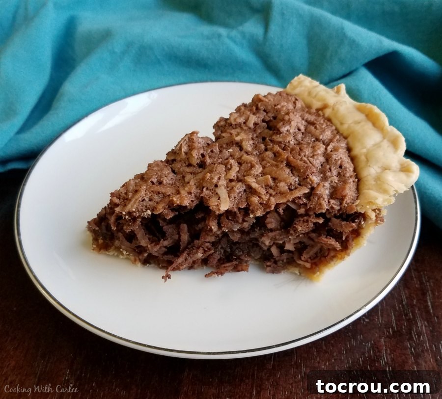 A perfectly cut slice of the chocolate coconut pie, ready to be enjoyed.