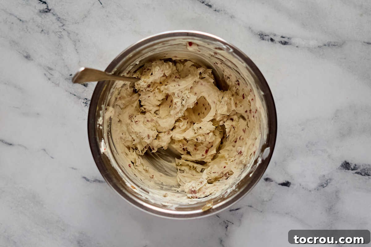 Creamy Jalapeno Popper Chicken 4 Mixing bowl filled with cream cheese, jalapeno, and bacon mixture ready to be stuffed in chicken breasts.