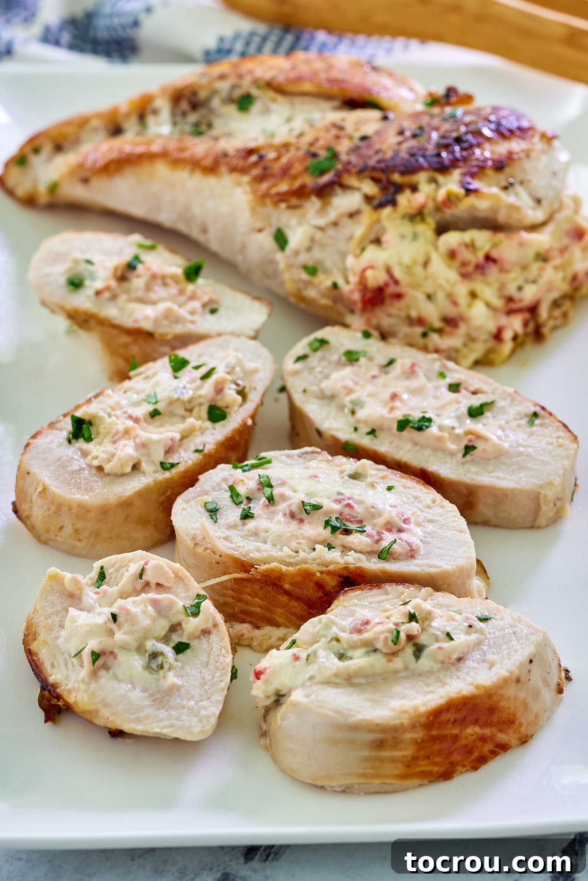 Creamy Jalapeno Popper Chicken 7 Close up of sliced chicken breast showing the juicy chicken and warm and gooey cream cheese, bacon, and jalapeno filing inside.