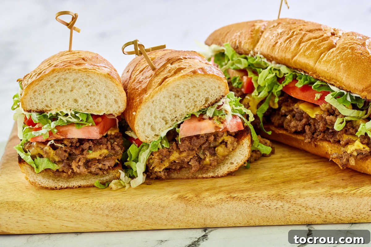 Chopped cheese sandwich halves showing ground beef and cheese filling with toppings next to a whole sandwich.