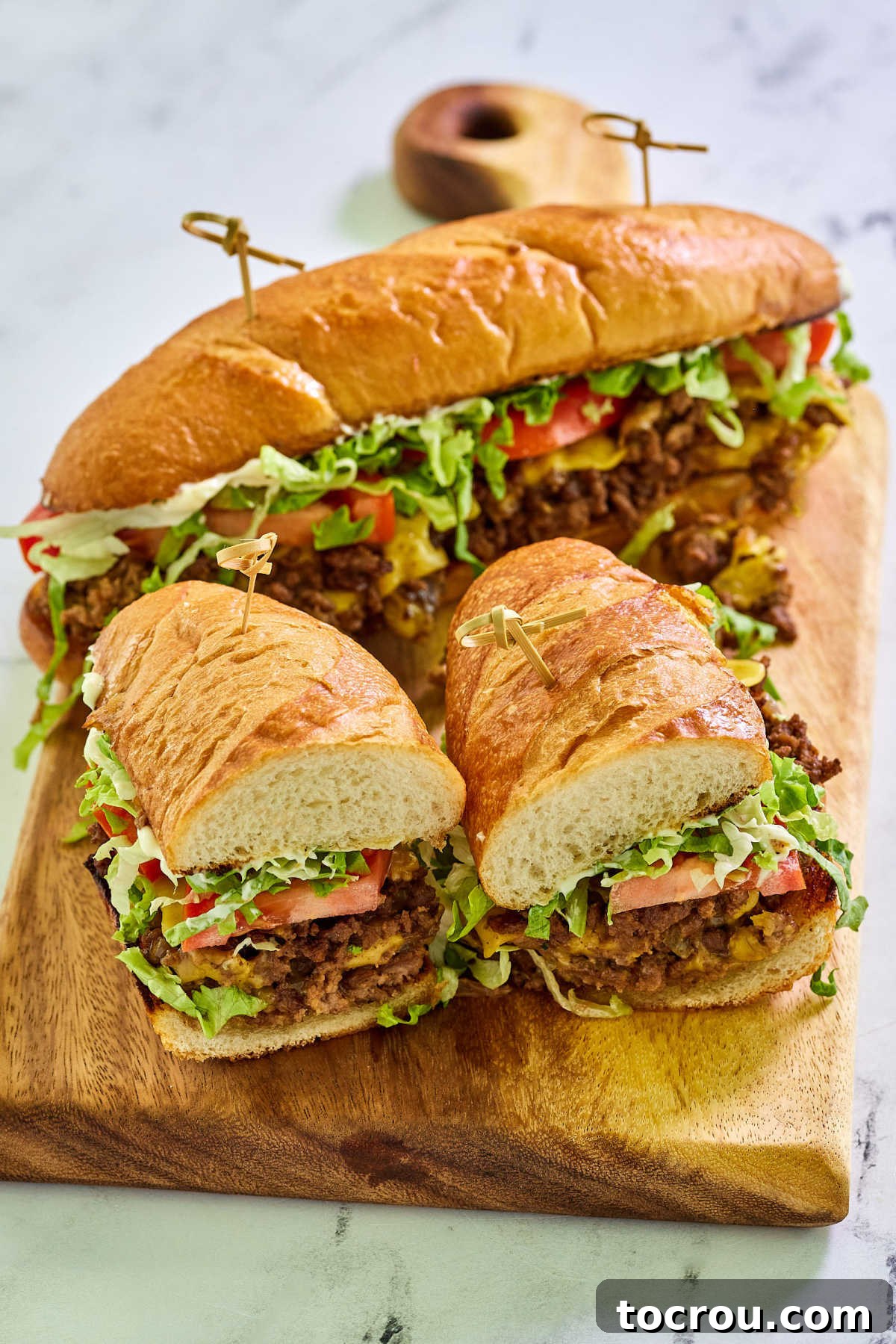 Chopped cheese sandwich on a good hoagie roll with tomato, lettuce and mayonnaise.