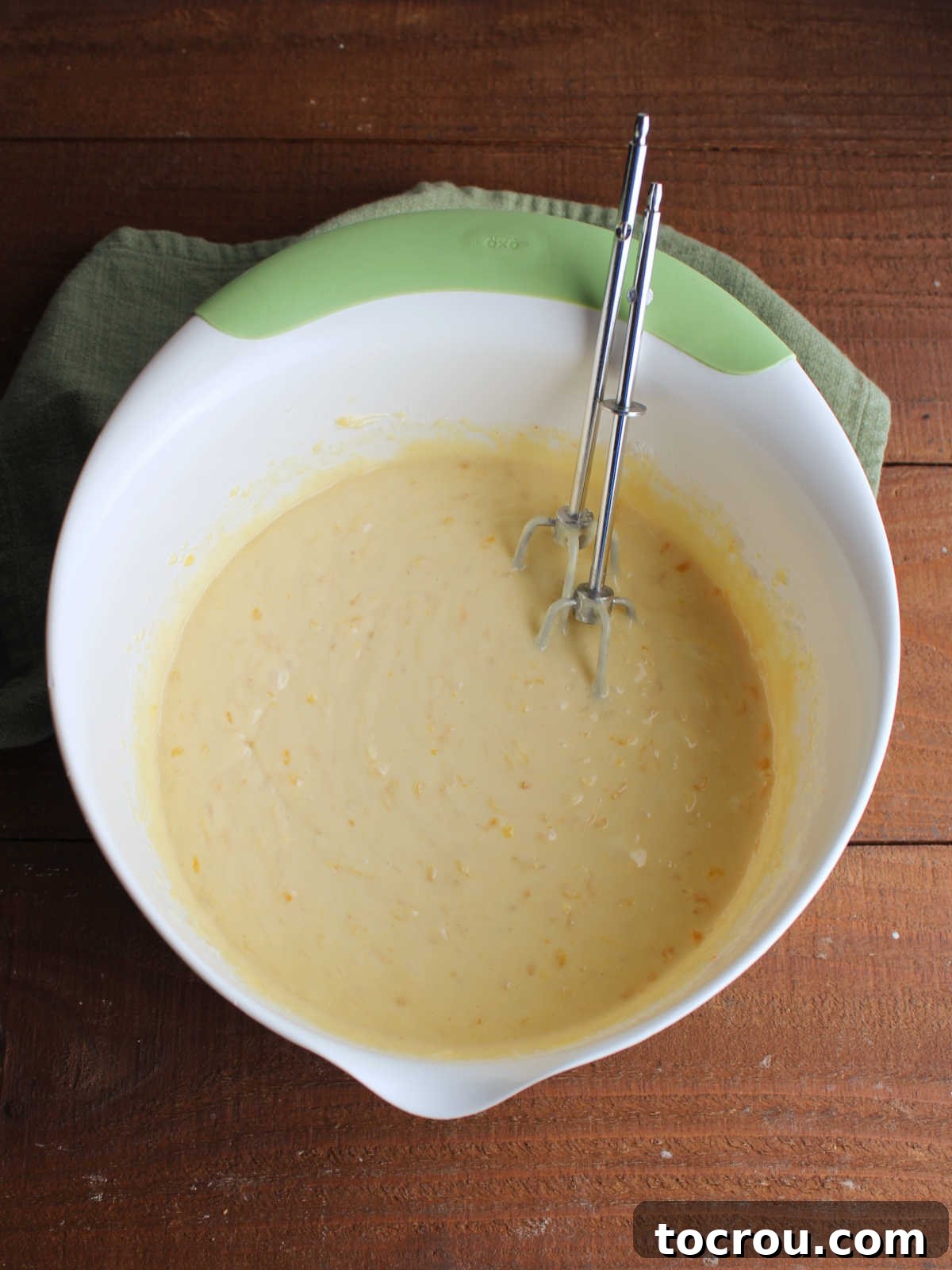 Ready-to-Bake Cake Batter Smooth, vibrant orange cake batter, perfectly mixed and aerated, waiting to be poured into a 9x13-inch cake pan for baking.