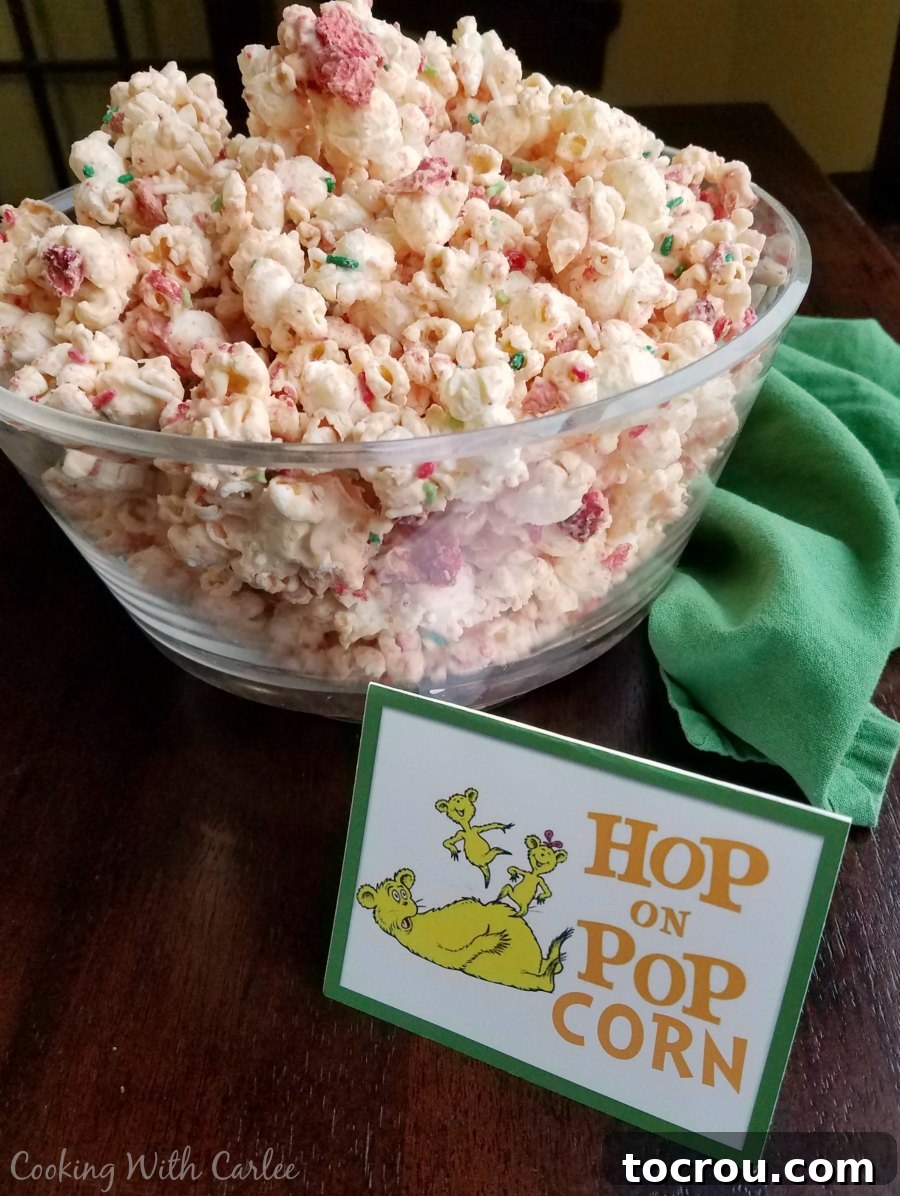 Hop on Popcorn Large bowl brimming with colorful strawberries and cream popcorn, presented with a 'Hop on Popcorn' sign.
