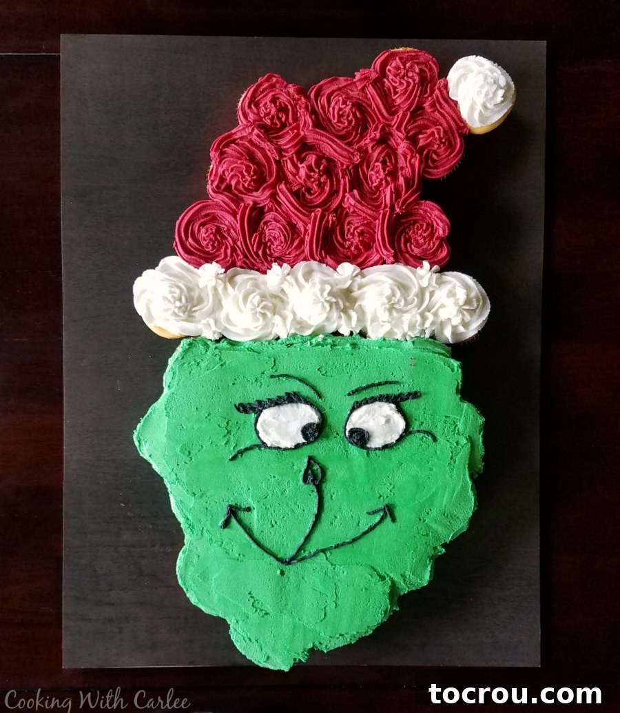 Grinch Cupcake Cake Grinch cupcake pull-apart cake shaped like a Santa hat, a creative dessert for a Dr. Seuss themed birthday party.