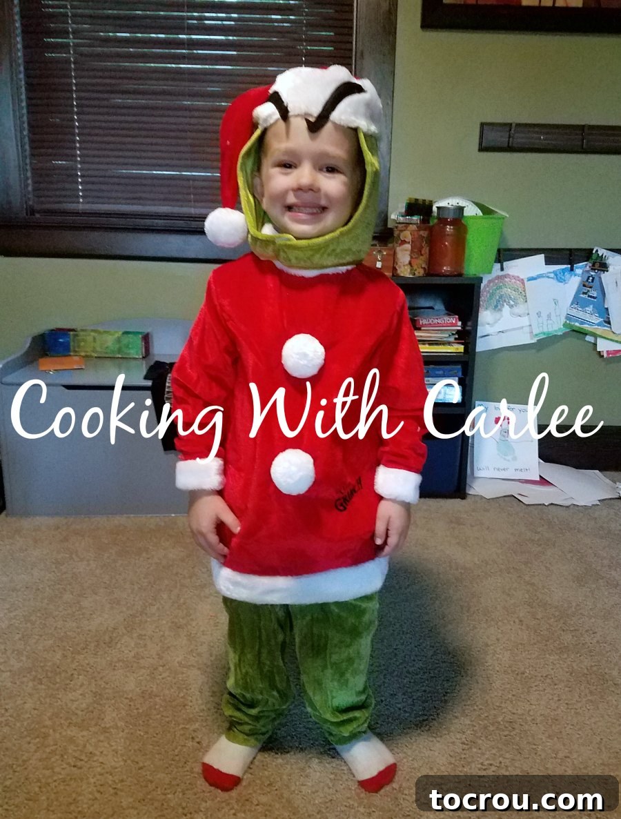 Grinch Costume Invitation Small child dressed in a adorable Grinch Halloween costume, perfect for Dr. Seuss party invitations.