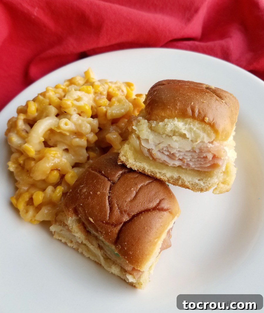 Classic Sliders for Everyone Hot turkey, ham, and cheese sliders served on a plate with corny mac and cheese, as an alternative to green eggs.