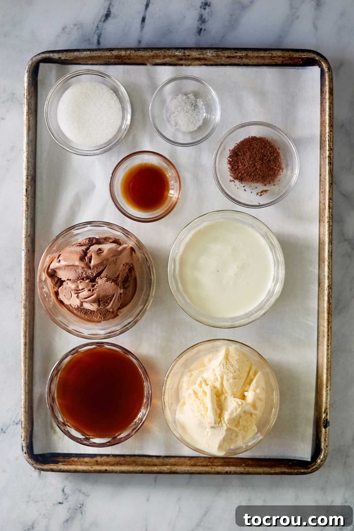Ingredients including coffee, vanilla ice cream, chocolate ice cream, heavy cream, sugar, vanilla, and chocolate shavings, ready to be made into old-fashioned coffee punch.