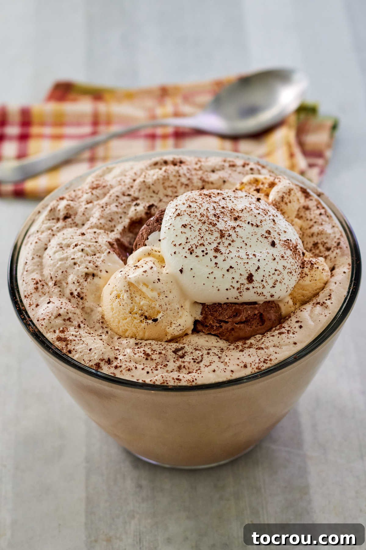 Old-fashioned creamy coffee punch in a glass mug with ice cream and whipped cream on top, ready to be enjoyed.