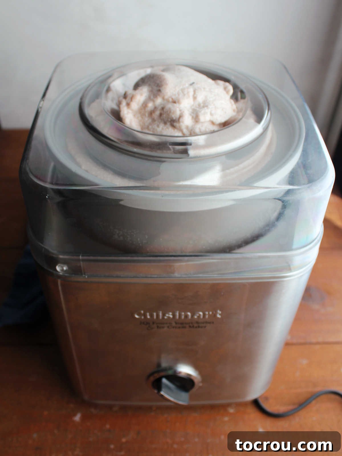 Ice cream maker filled with soft apple butter ice cream after it has been churned, ready to go in the freezer.