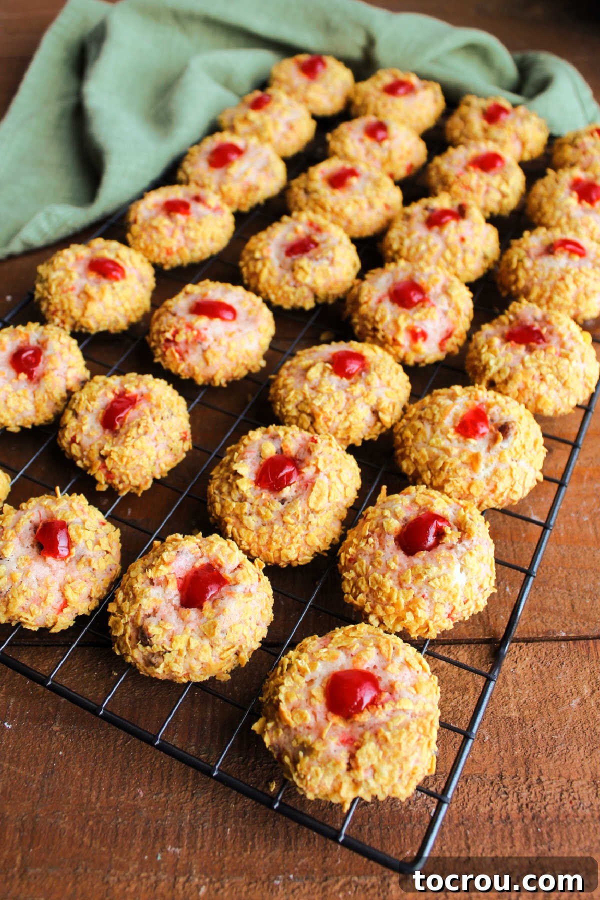 Freshly baked cherry winks on a wire cooling rack. 