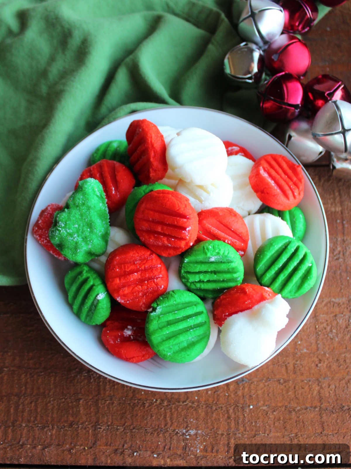 Creamy Dream Mints 8 Bowl of mostly round cream cheese mints with a couple of holiday shapes scattered around.