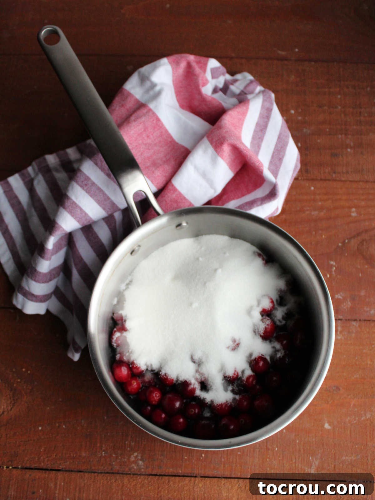 Crimson Cranberry Chill 3 Saucepan with whole cranberries, sugar, water, and salt ready to be cooked into sauce.