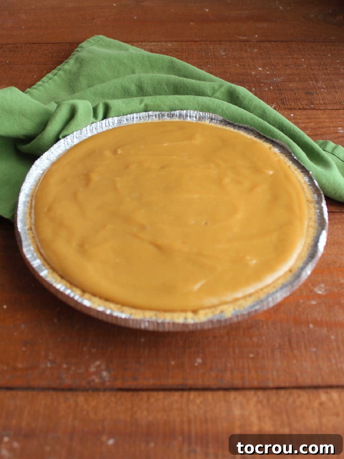 Maple custard filling in graham cracker crust, ready to chill. 