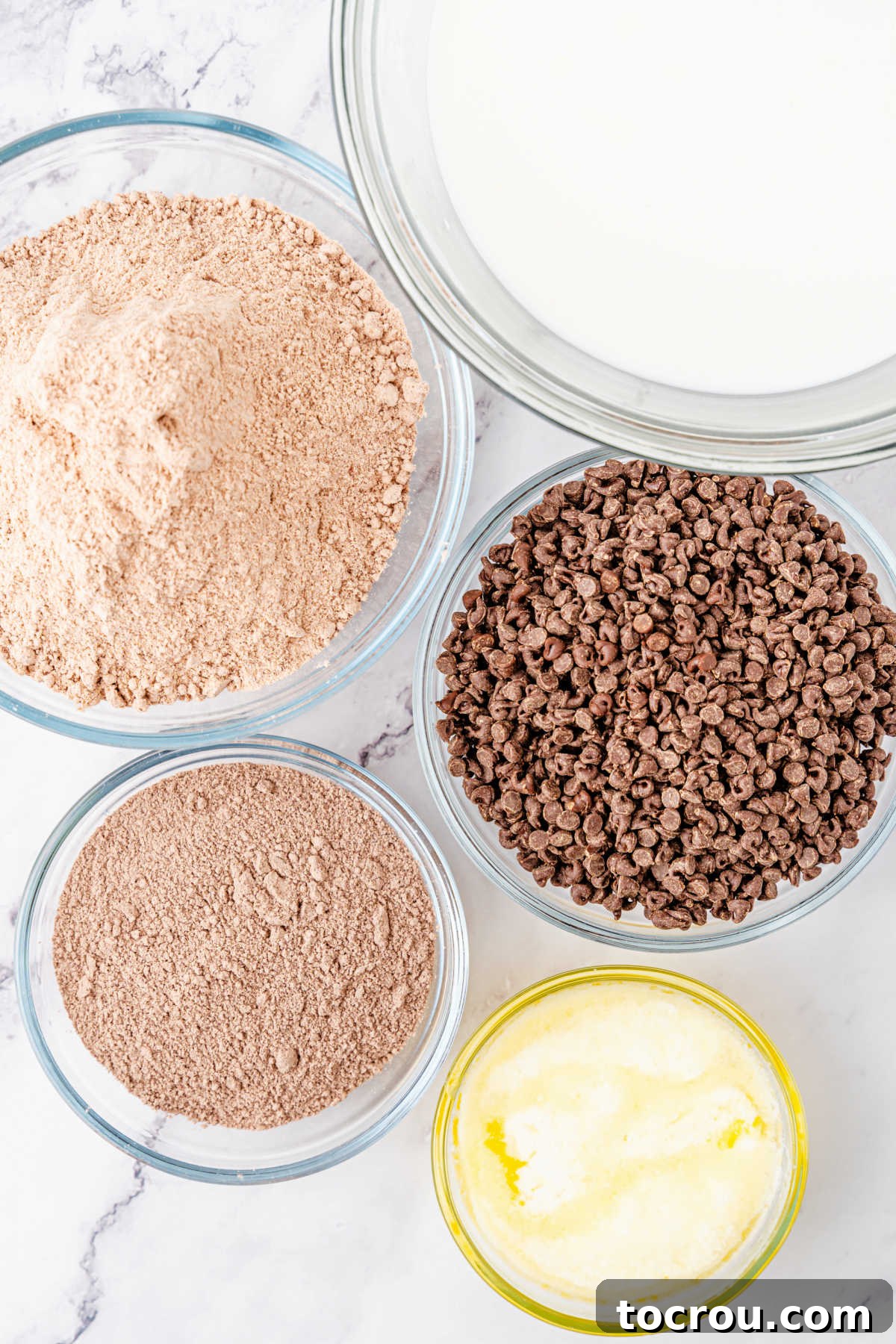 Effortless Chocolate Indulgence 3 Ingredients including chocolate cake mix, instant pudding mix, milk, melted butter, and chocolate chips ready to be made into chocolate dump cake.