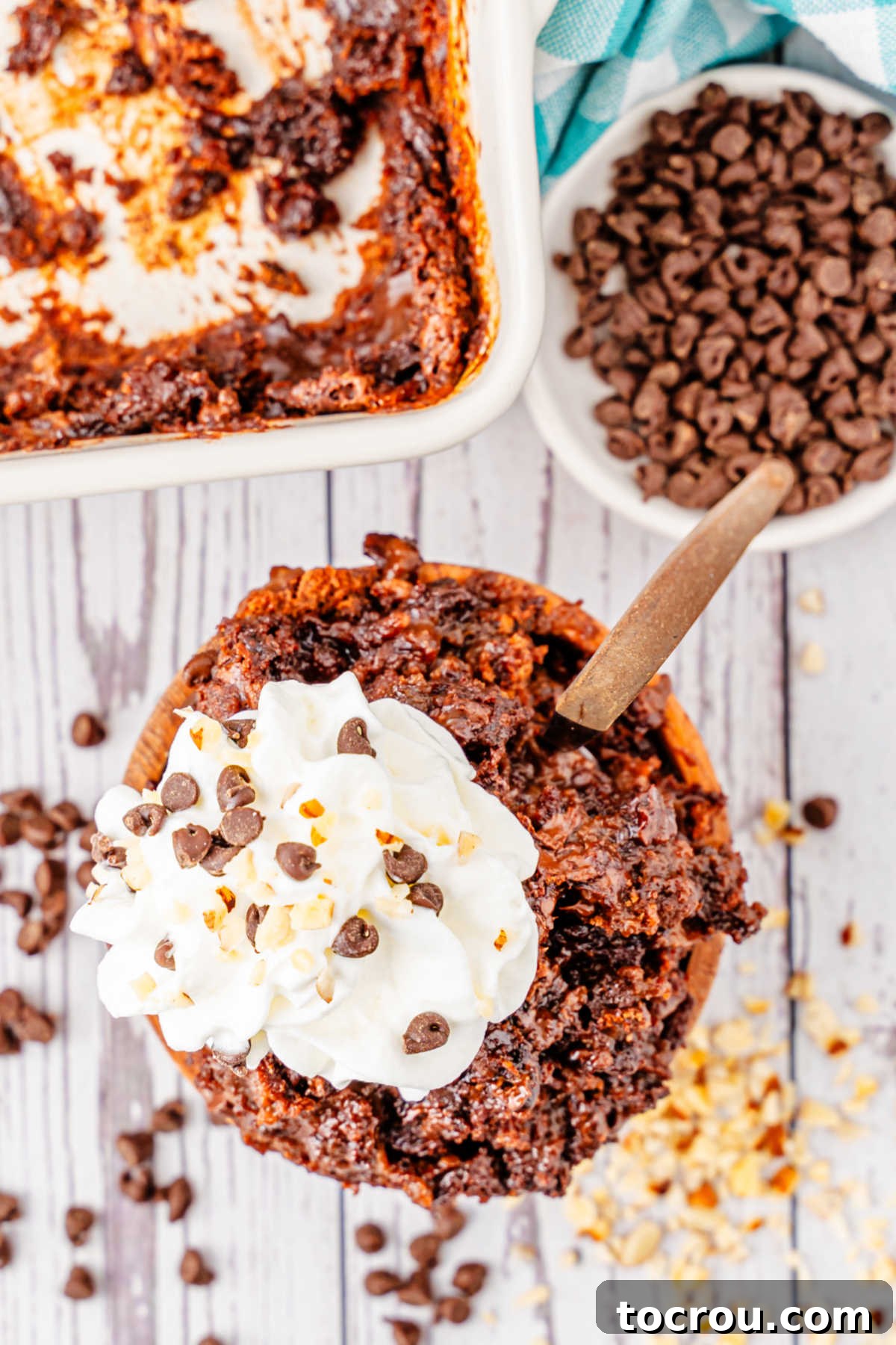 Effortless Chocolate Indulgence 6 Bowl of chocolate dump cake served with whipped cream and chocolate chips.