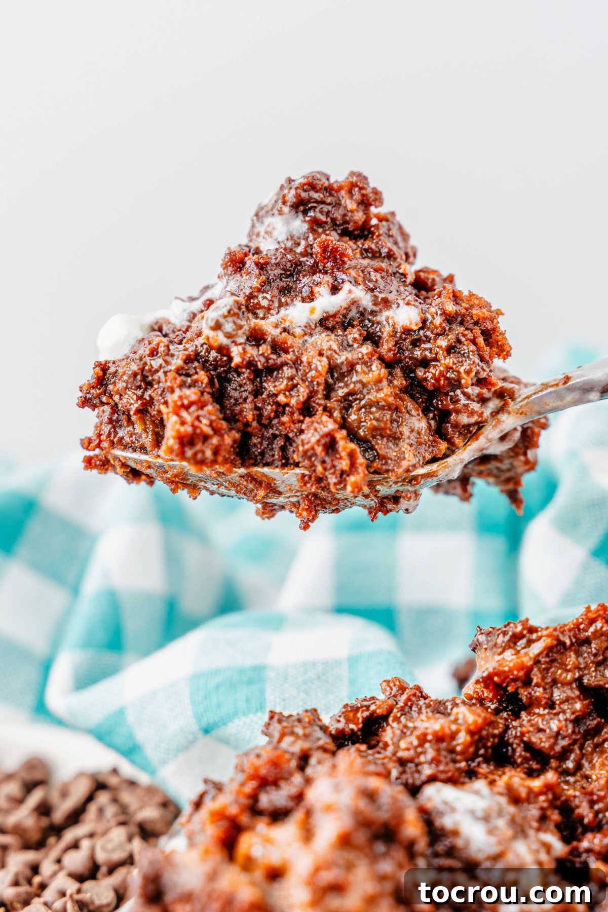 Effortless Chocolate Indulgence 8 Bite of rich chocolate dump cake on spoon, showing slightly gooey cakey texture, ready to eat.