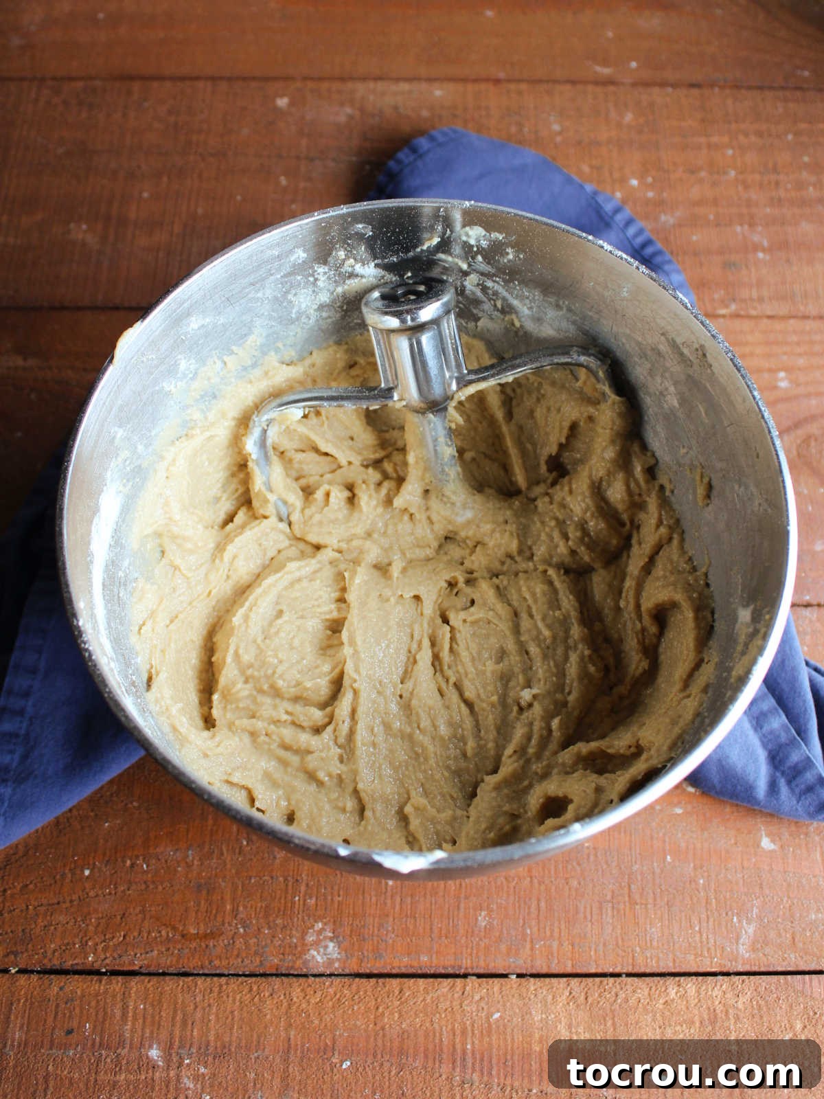 Pound Cake Batter in Mixer A mixer bowl filled with thick, creamy brown sugar pound cake batter, showcasing the smooth consistency achieved with sour cream.