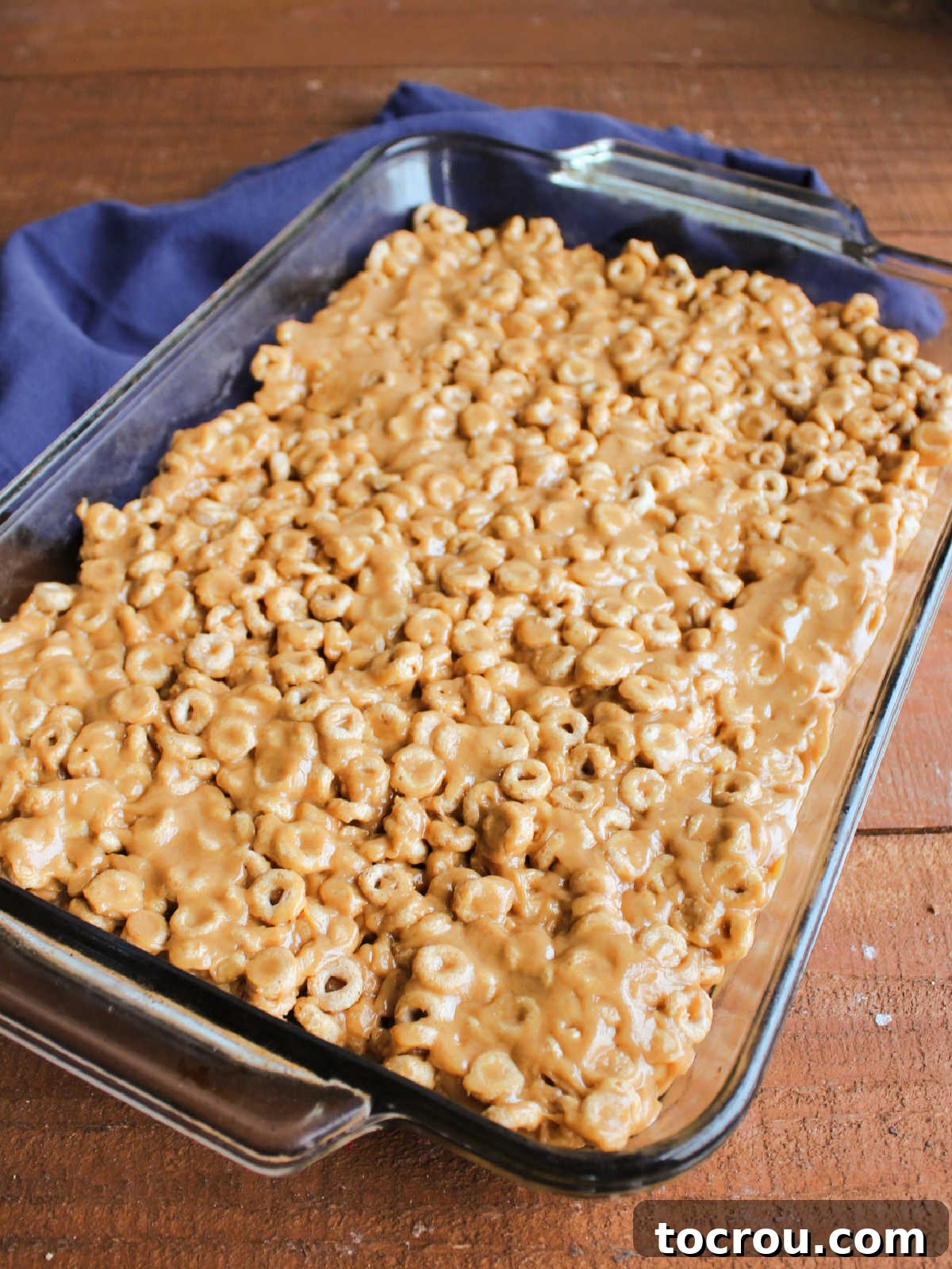 Pan of Cheerio Bars A full 9x13-inch baking pan filled with freshly made no-bake peanut butter Cheerio bars, perfectly set and ready to be cut into squares.