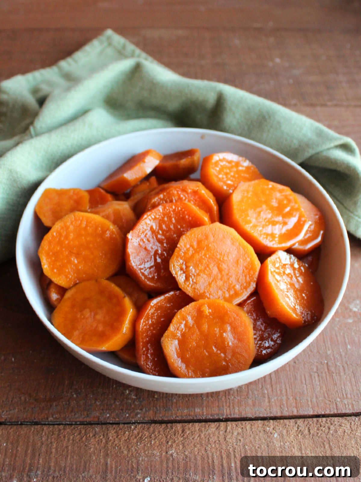 Bowl of candied sweet potatoes after they have been scooped out of the slow cooker, ready to serve. 