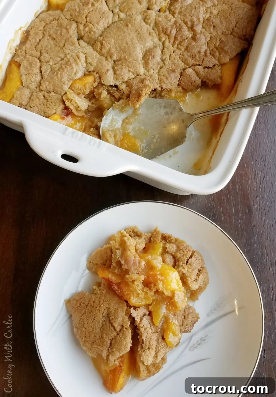 Cobbler in Pan and on Plate serving of brown sugar peach cobbler on plate next to 9x13 pan with remaining dessert in it.