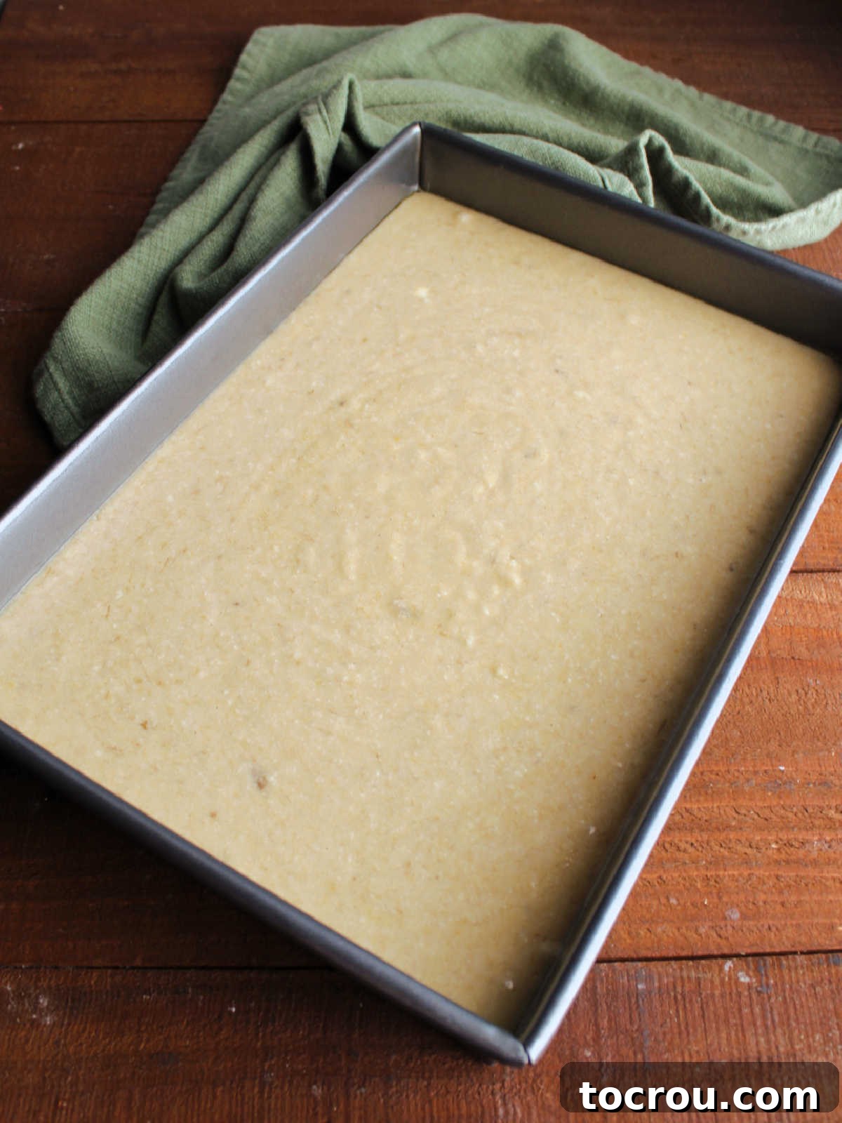 Golden Banana Cake Crowned with Brown Sugar Glaze 6 Banana cake batter in 9x13-inch pan ready to go in the oven.