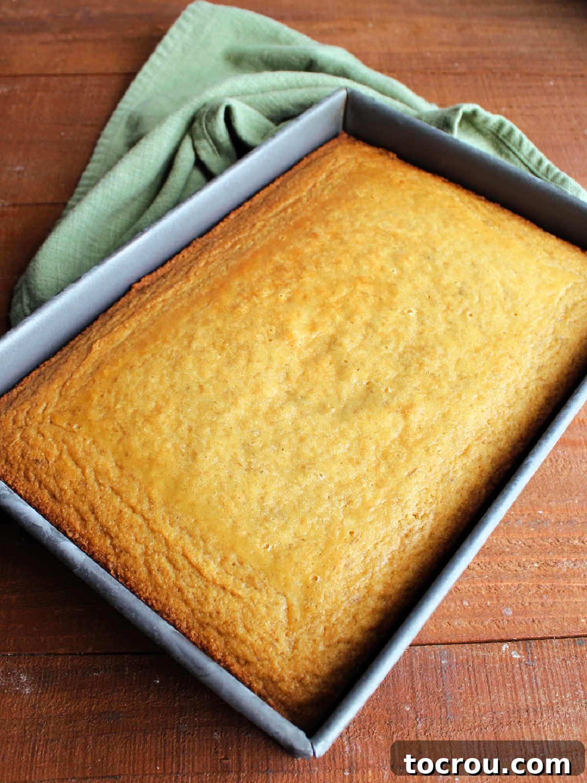 Golden Banana Cake Crowned with Brown Sugar Glaze 8 9x13-inch pan with cooled banana cake, ready for frosting.