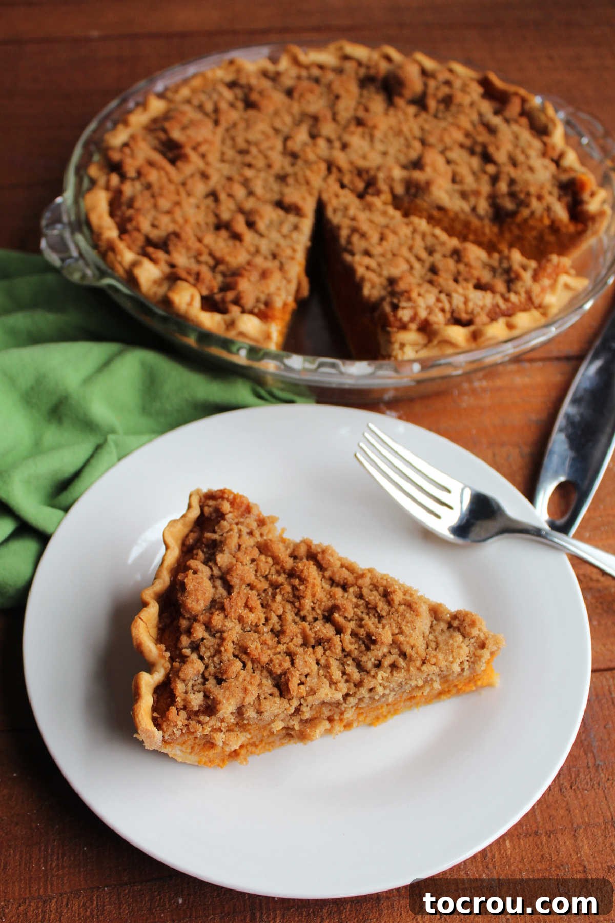 Spiced Carrot Pie with Crunchy Cinnamon Streusel 11 Piece of carrot pie served next to remaining pie both topped with buttery crumbs.