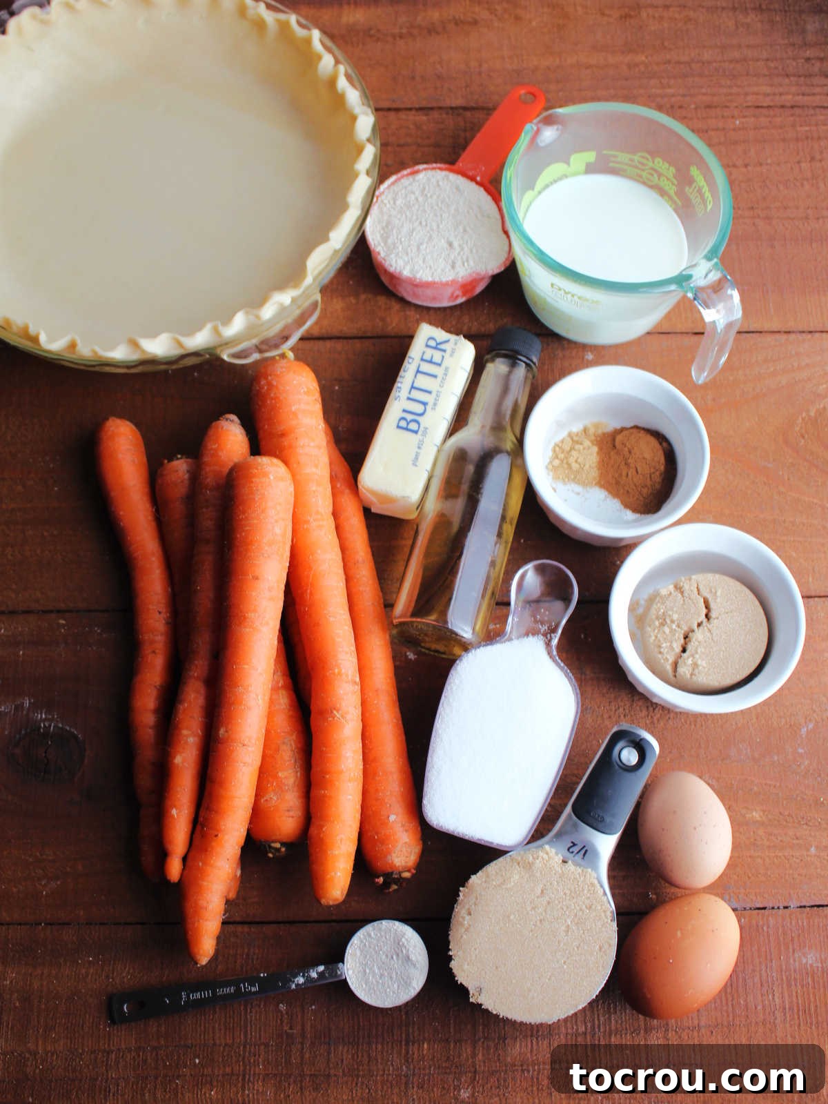 Spiced Carrot Pie with Crunchy Cinnamon Streusel 4 Ingredients including carrots, sugar, brown sugar, milk, eggs, butter, cinnamon, ginger, flour, vanilla, and pie crust ready to be made into a carrot crumb pie.