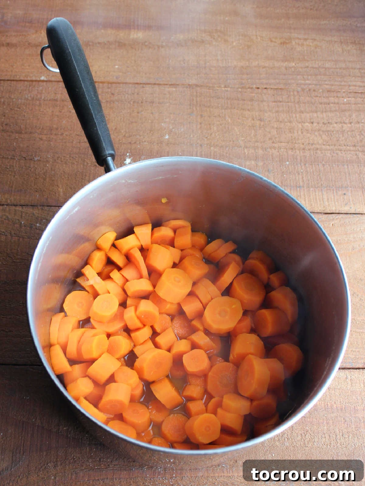 Spiced Carrot Pie with Crunchy Cinnamon Streusel 5 Saucepan with chunks of carrots boiled in water.