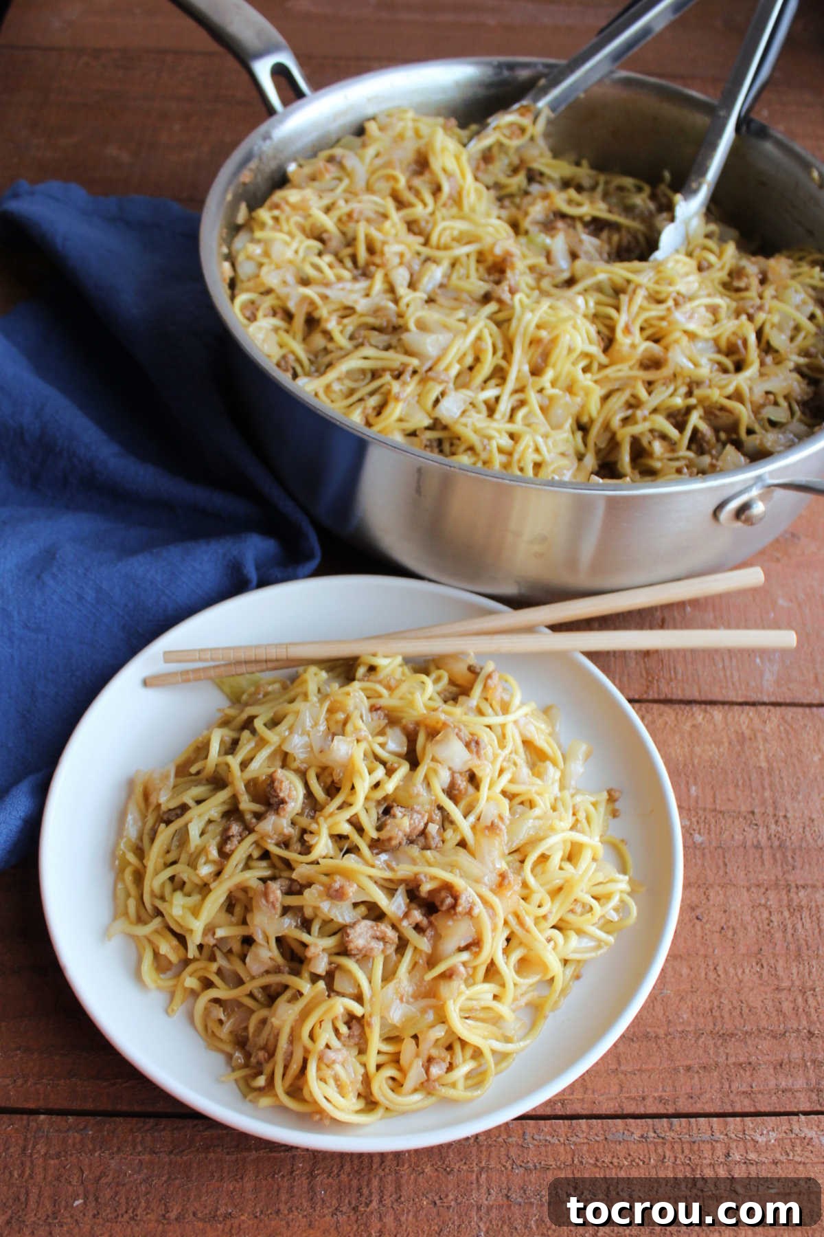 A hearty plate of pork chow mein sits invitingly in front of the skillet it was cooked in, ready for a satisfying dinner.
