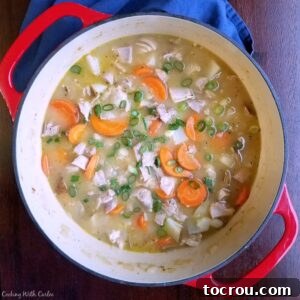 pot filled with easy chicken stew loaded with chunks of carrots and potatoes.