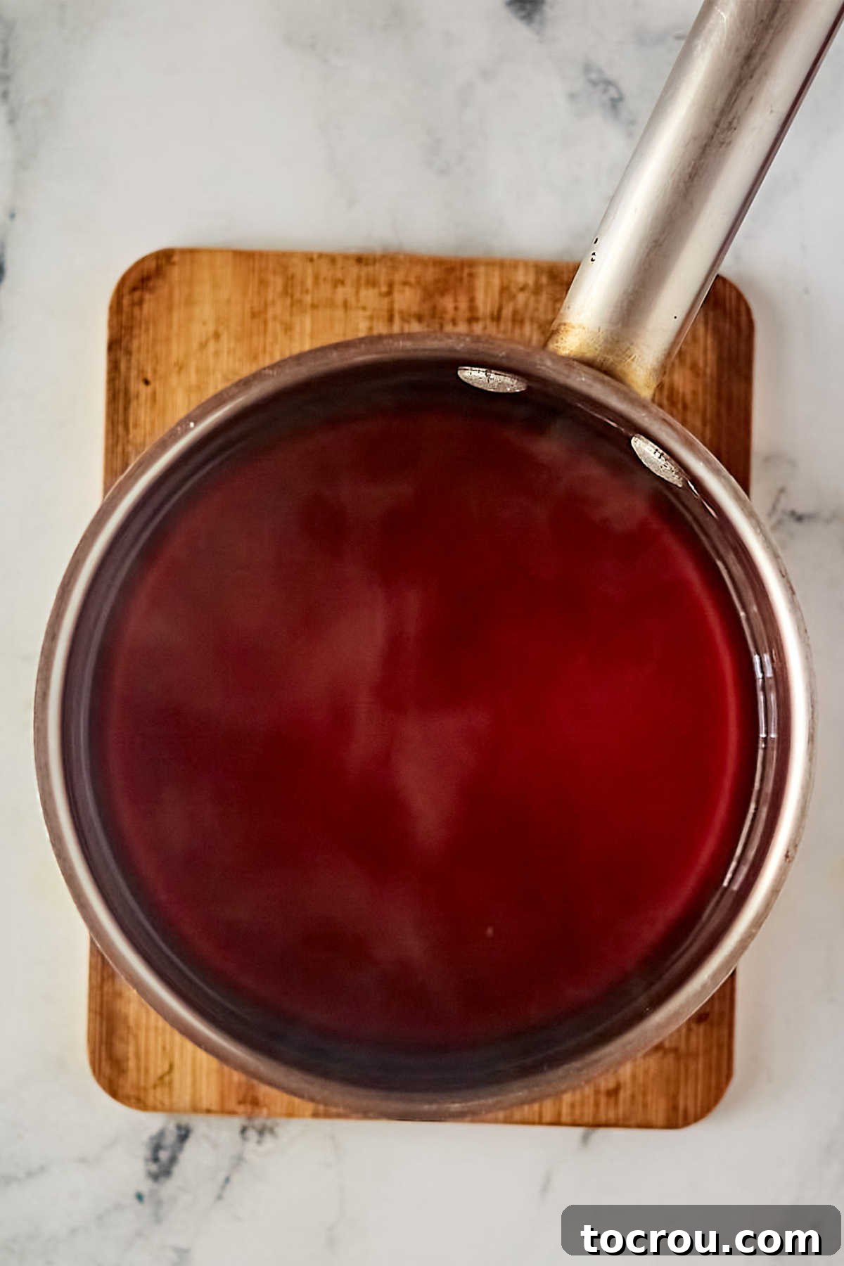 Steeped tea in a saucepan, ready for the next steps of cake batter preparation. Sauce pan with tea inside after tea bags have been steeped in boiling water, ready to be used in cake batter.
