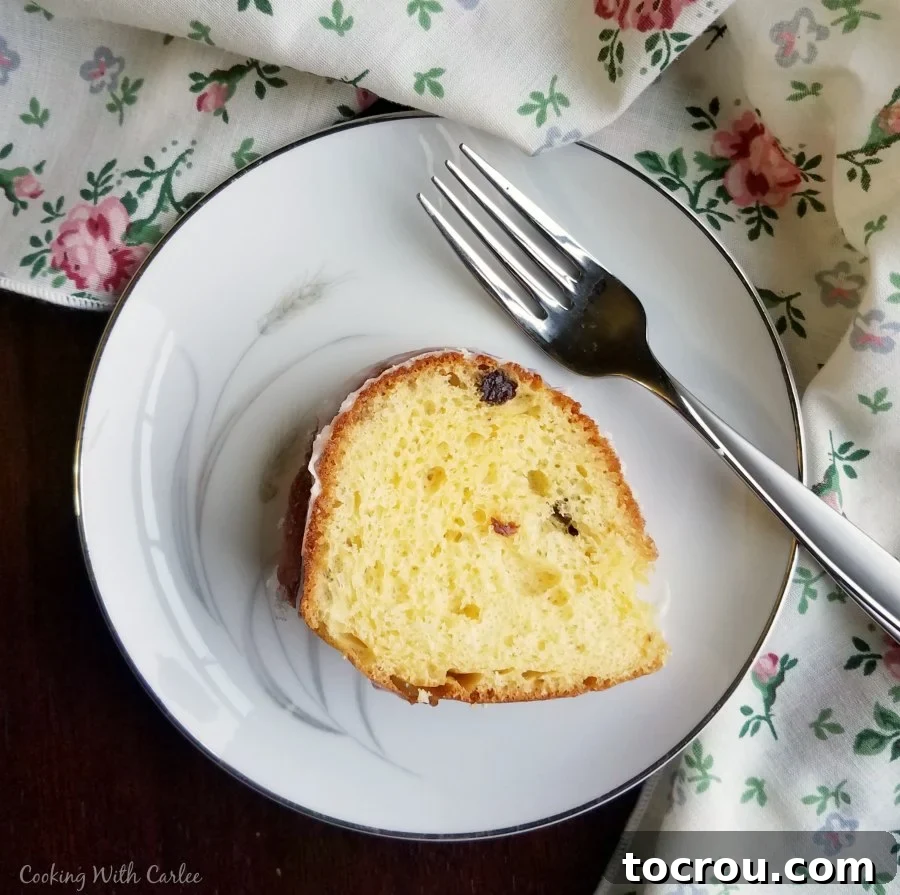 Slice of airy lemon babka on small plate with fork, ready to eat.
