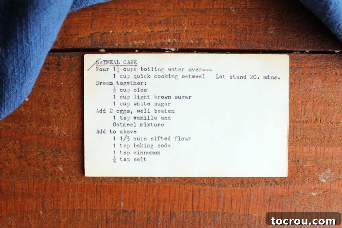Slightly yellowed index card with typewritten recipe for oatmeal cake on it. 