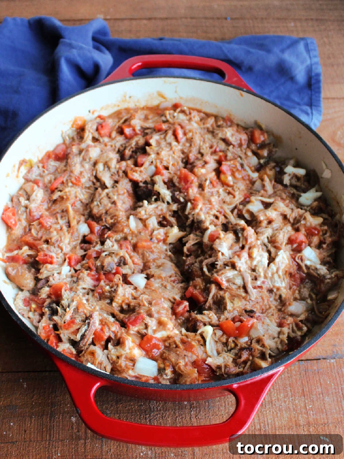 Velvety BBQ Pulled Pork Pasta 3 Pan of pulled pork mixed with diced tomatoes, bbq sauce, onions, and cream cheese.