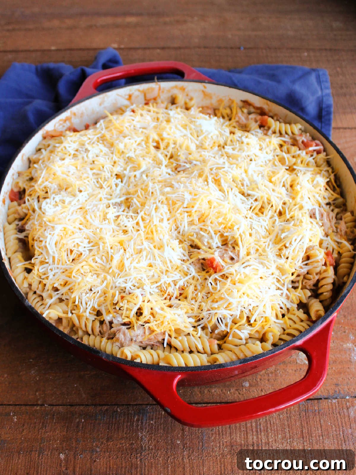 Velvety BBQ Pulled Pork Pasta 5 Shredded cheese sprinkled on top of pulled pork and pasta mixture, ready to go in the oven for a bit.