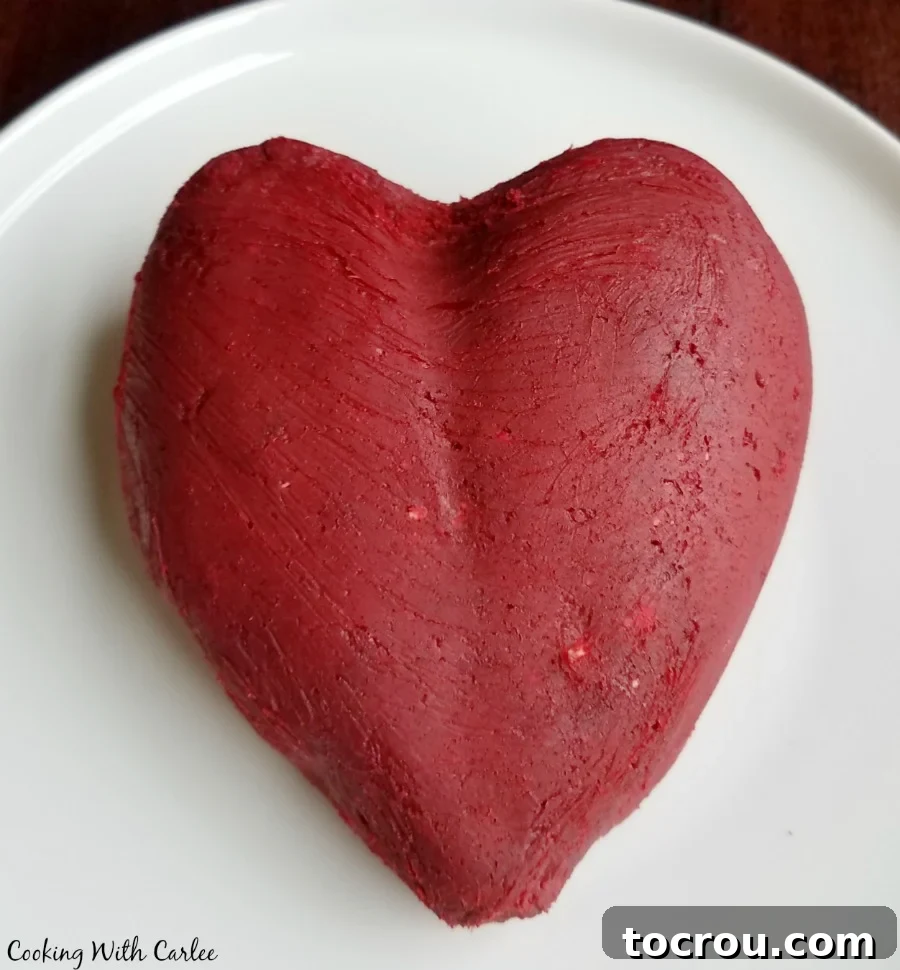 Red Velvet Cheesecake Ball 2 red velvet cheese ball hand shaped into a heart shape, ready to be coated in white chocolate