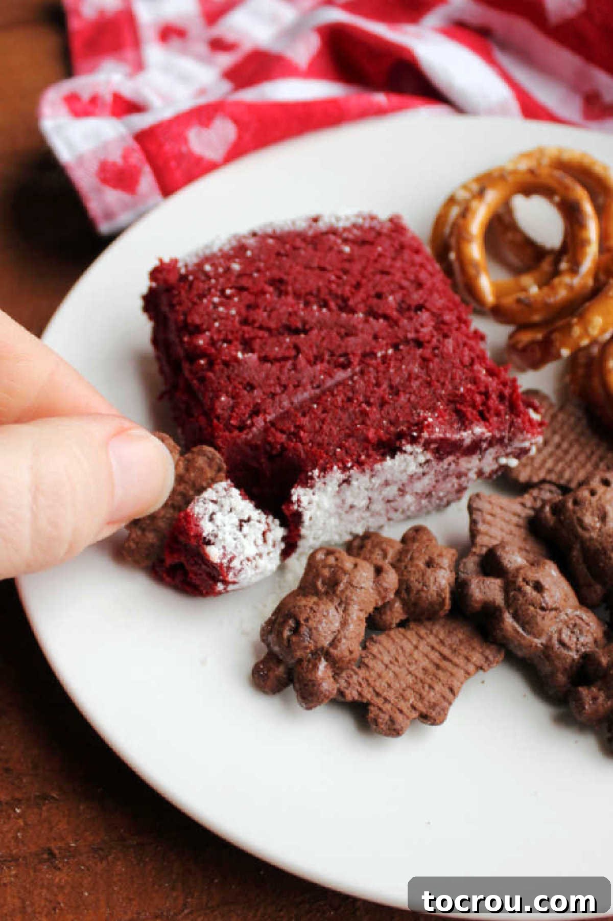 Red Velvet Cheesecake Ball 6 plate with helping of red velvet cheese ball, cookies and pretzels ready to eat.
