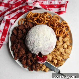 Red Velvet Cheesecake Ball 7 looking down on platter filled with white chocolate covered red velvet cheese ball and dippers
