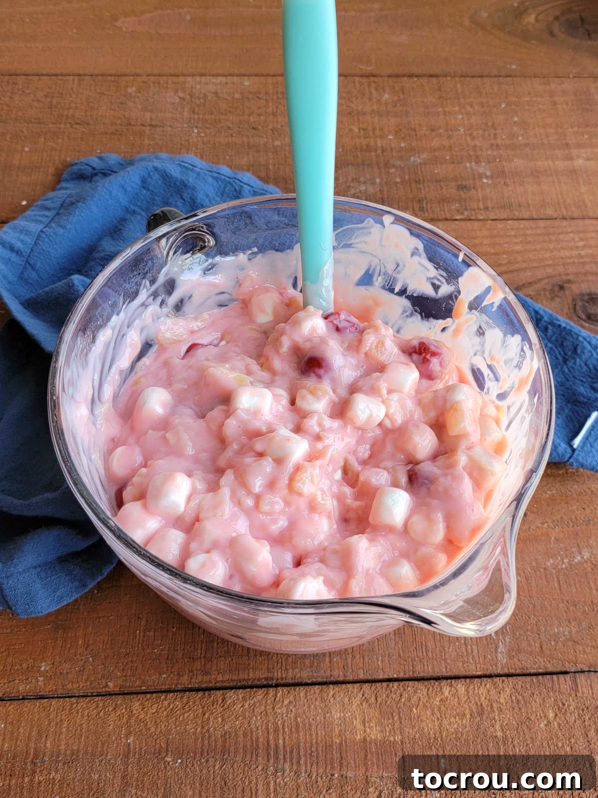 Bowl of cherry pie filling, crushed pineapple, sweetened condensed milk, and marshmallows stirred together. 