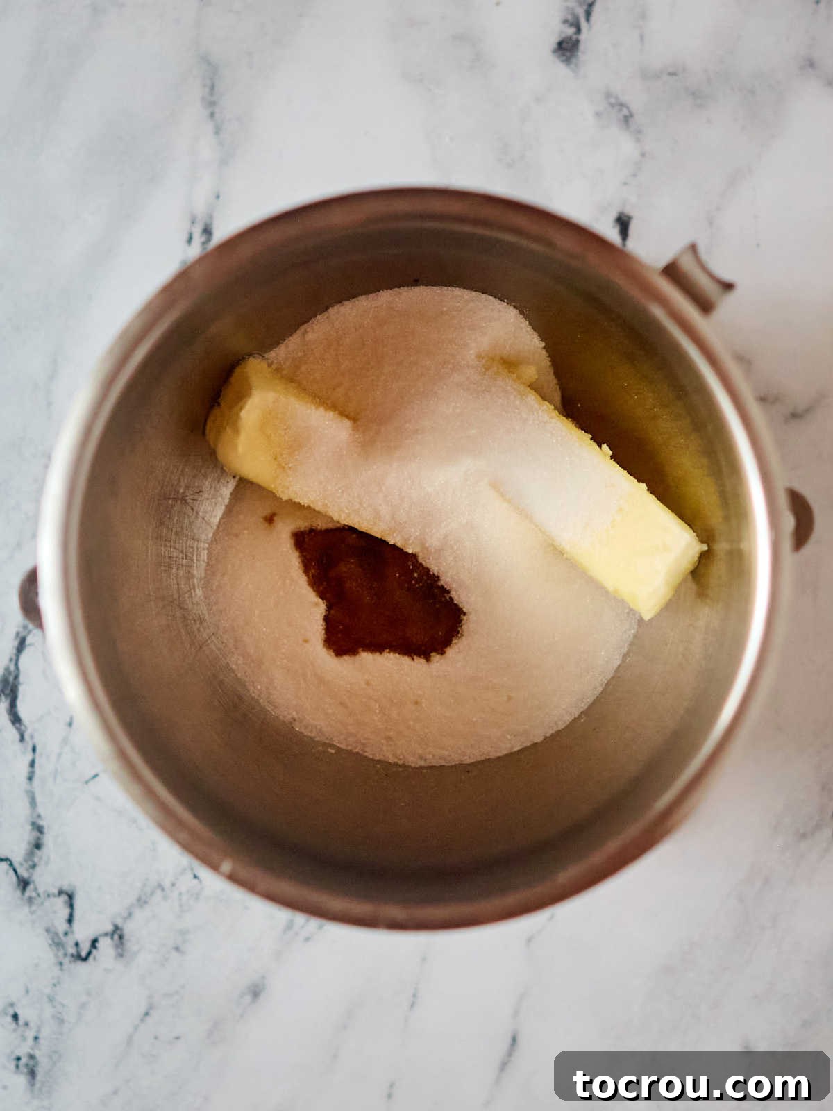 Perfectly softened butter, fine granulated sugar, and pure vanilla extract carefully placed in a stand mixer bowl, poised to be expertly beaten into a creamy, airy base for the French silk pie filling.