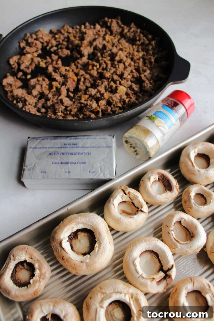 Savory Sausage Stuffed Mushrooms 2 Ingredients including garlic salt, cream cheese, browned sausage and mushroom caps ready to be made into stuffed mushrooms.